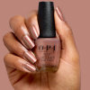 Rosébrun karamellton med pärlglans och varm retrolyster opi most requested route beer float nagellack i karamellbrun roséton med bronsfärgat pärlemorskimmer och glansig finish
